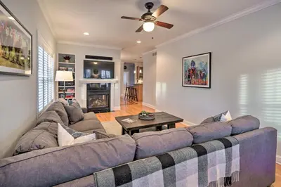 a living room with a couch and a ceiling fan at Stunning House with Deck, Game Room and Home Gym! in Saratoga Springs