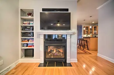 a living room with a fireplace with a flat screen tv at Stunning House with Deck, Game Room and Home Gym! in Saratoga Springs