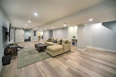 a living room with a couch and a table at Stunning House with Deck, Game Room and Home Gym! in Saratoga Springs