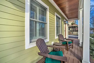 two chairs on the porch of a house at Stunning House with Deck, Game Room and Home Gym! in Saratoga Springs
