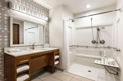 a bathroom with a sink and a tub and a shower at Home2 Suites Long Island City/Manhattan View in Queens