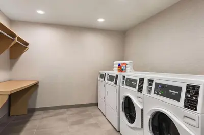 a laundry room with a washer and dryer at Home2 Suites Long Island City/Manhattan View in Queens