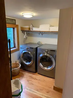 a laundry room with two washing machines and a window at Harpersfield House /North West Catskills + sauna in Jefferson