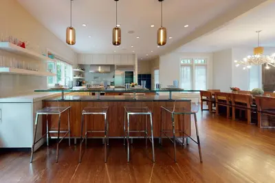a kitchen with a large island with bar stools at Sunny Day on Taunton Lake in Newtown