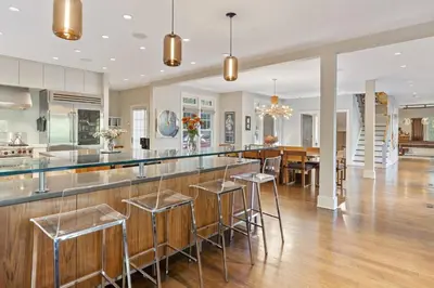 a kitchen and dining room with a bar with stools at Sunny Day on Taunton Lake in Newtown