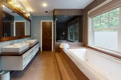 a bathroom with two sinks and a tub and a window at Sunny Day on Taunton Lake in Newtown