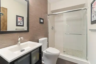 a bathroom with a toilet and a sink and a shower at Sunny Day on Taunton Lake in Newtown