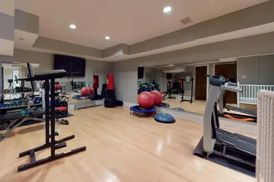 a gym with several treadmills and exercise equipment at Sunny Day on Taunton Lake in Newtown