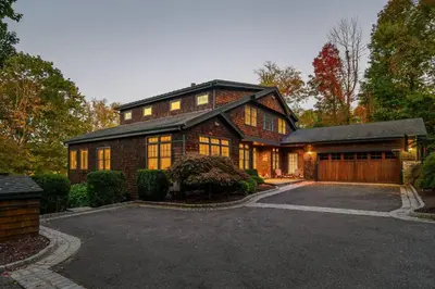 a large house with a garage in front of it at Sunny Day on Taunton Lake in Newtown