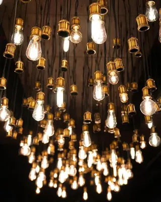 a bunch of lights hanging from a ceiling at 42 Hotel Williamsburg in Brooklyn
