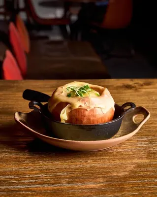 a bowl of food sitting on a table at 42 Hotel Williamsburg in Brooklyn