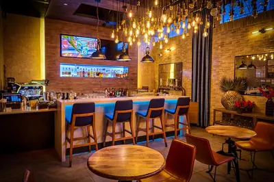 a bar with chairs and tables in a restaurant at 42 Hotel Williamsburg in Brooklyn