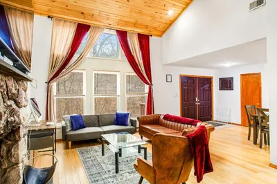 a living room with a couch and a table at Highland Hideaway in East Stroudsburg