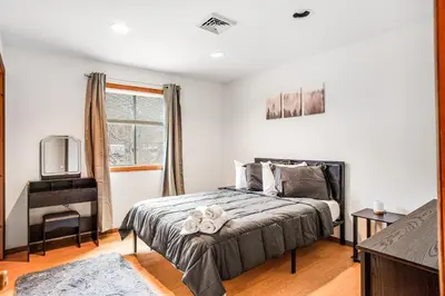 a bedroom with a bed and a desk and a television at Highland Hideaway in East Stroudsburg