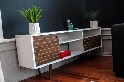 a white shelf with two potted plants on it at A Luxurious 5 star Location 2 QUEEN Bed’s TROY in Troy