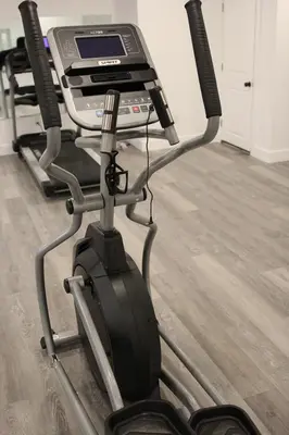 a treadmill with a laptop on top of it at A Luxurious 5 star Location 2 QUEEN Bed’s TROY in Troy