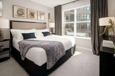 a bedroom with a large bed and a window at Hyatus Luxury Residences City Crossing in New Haven