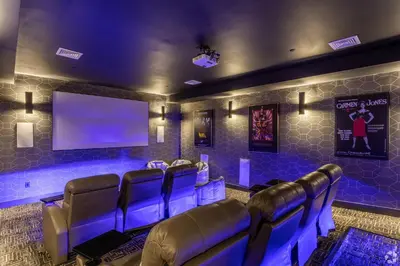 a room with a bunch of chairs and a flat screen tv at Hyatus Luxury Residences City Crossing in New Haven