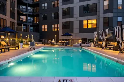 a swimming pool in front of a building at Hyatus Luxury Residences City Crossing in New Haven