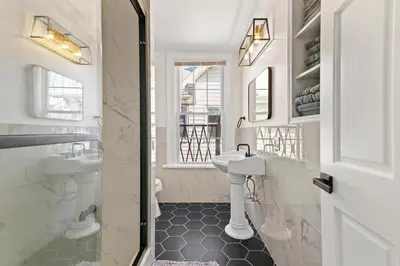 a white bathroom with a sink and a toilet at Orange Oasis in the Heart of East Rock with FREE parking near DT and Yale in New Haven