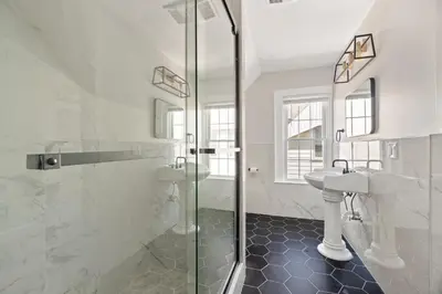 a bathroom with a glass shower and a sink at Orange Oasis in the Heart of East Rock with FREE parking near DT and Yale in New Haven