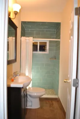 a bathroom with a sink and a toilet and a shower at MOTELCASA Guest House Newark NJ in Newark