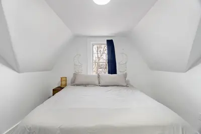 a white bed in a white room with a window at Cozy Gem in the Heart of East Rock with FREE Parking near Yale and DT in New Haven