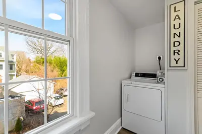 a white kitchen with a window and a refrigerator at Casa Soleada in East Rock near DT and Yale SOM with FREE Parking and King Bed in New Haven