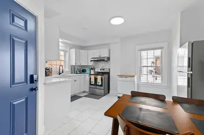 a kitchen with a table and a dining room at Casa Soleada in East Rock near DT and Yale SOM with FREE Parking and King Bed in New Haven