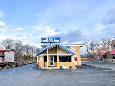 a building with a sign that reads rest inn at Utica Rest Inn in Utica