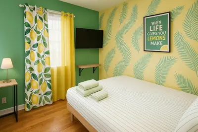 a bedroom with a bed with yellow and green walls at Lemon Vibes room in Guesthouse in New York