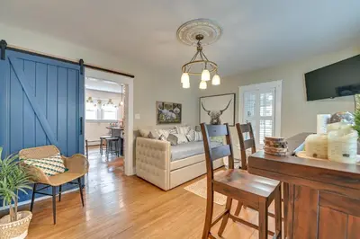 a living room with a couch and a table at Family-Friendly Glens Falls Home with Sun Porch in Glens Falls
