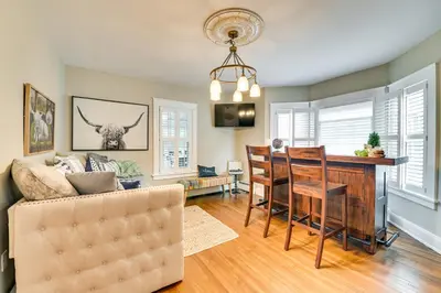 a living room with a couch and a table and chairs at Family-Friendly Glens Falls Home with Sun Porch in Glens Falls