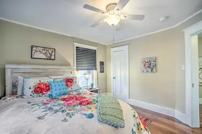 a bedroom with a bed with a ceiling fan at Family-Friendly Glens Falls Home with Sun Porch in Glens Falls
