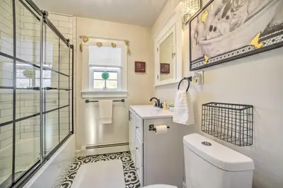 a bathroom with a toilet and a sink and a shower at Family-Friendly Glens Falls Home with Sun Porch in Glens Falls