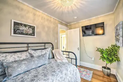 a bedroom with a bed and a potted plant at Family-Friendly Glens Falls Home with Sun Porch in Glens Falls