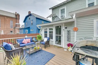 a patio with a couch and chairs on a deck at Family-Friendly Glens Falls Home with Sun Porch in Glens Falls