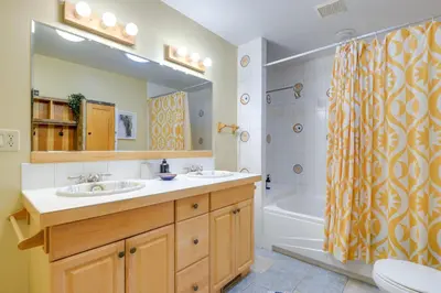 a bathroom with two sinks and a shower curtain at Storybook Stratton House 3 Mi to Mount Snow! in Stratton