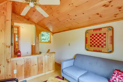 a living room with a blue couch at Storybook Stratton House 3 Mi to Mount Snow! in Stratton