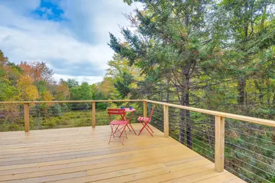 a deck with two chairs and a table on it at Storybook Stratton House 3 Mi to Mount Snow! in Stratton