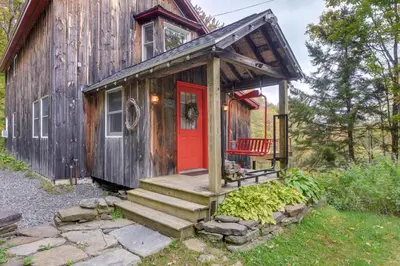 a tiny house with a red door and stairs at Storybook Stratton House 3 Mi to Mount Snow! in Stratton