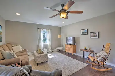 a living room with a couch and a ceiling fan at Stylish Pine Plains Home Near Parks and Hiking! in Pine Plains