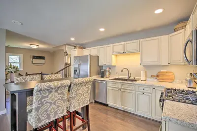 a kitchen with white cabinets and a stainless steel refrigerator at Stylish Pine Plains Home Near Parks and Hiking! in Pine Plains