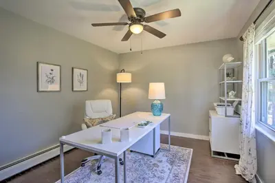 a room with a desk and a ceiling fan at Stylish Pine Plains Home Near Parks and Hiking! in Pine Plains