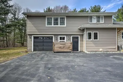 a house with a driveway with a garage at Stylish Pine Plains Home Near Parks and Hiking! in Pine Plains