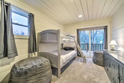 a bedroom with a bunk bed and a window at Spacious Cabin with Decks Near Saratoga Springs in Middle Grove