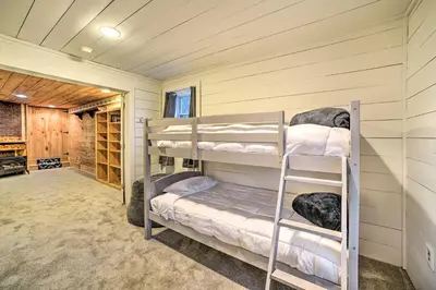 a bedroom with two bunk beds in a room at Spacious Cabin with Decks Near Saratoga Springs in Middle Grove