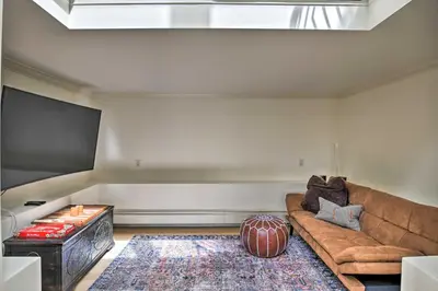 a living room with a couch and a flat screen tv at Catskill Getaway on 6 Acres with Swimming Pond! in Liberty