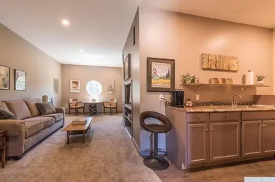 a living room with a couch and a kitchen at Spencertown Inn in Spencertown