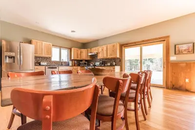 a kitchen with a large wooden table and chairs at Spencertown Inn in Spencertown